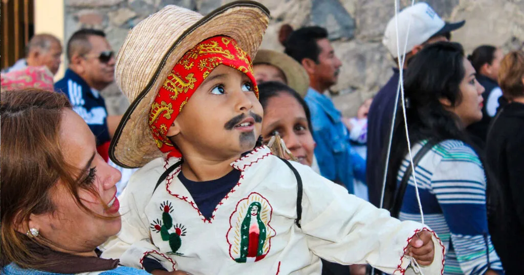 Boy dressed as Juan Diego in procession for the day of the Virgin of Guadalupe